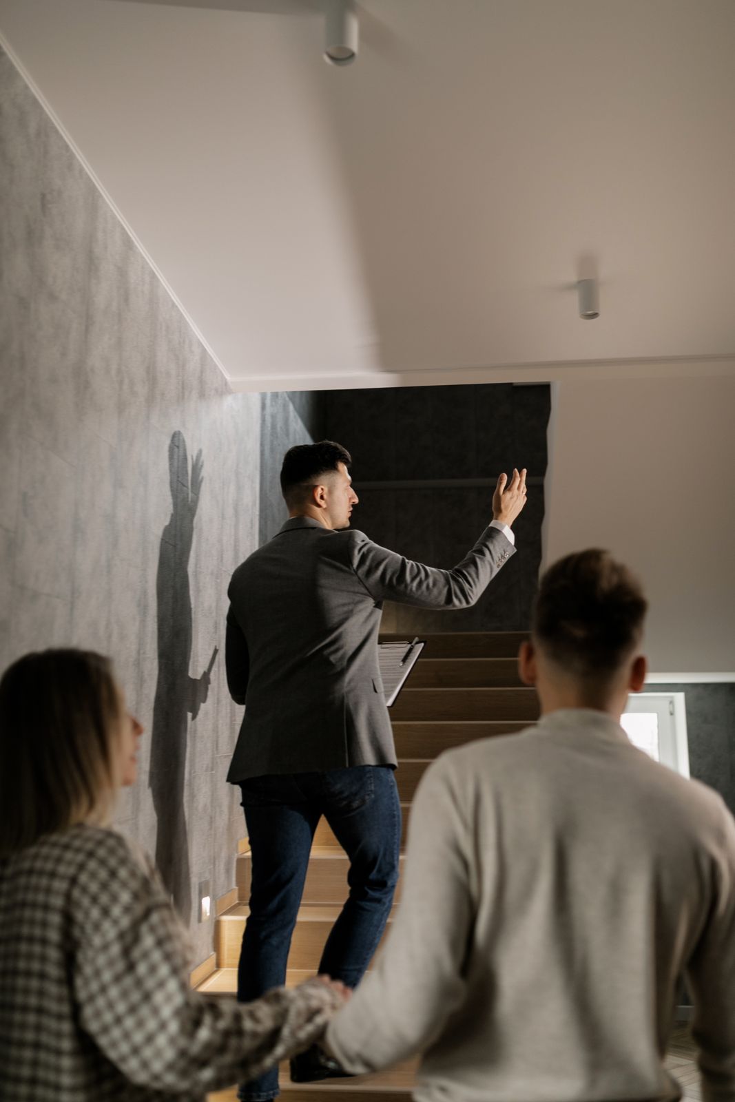 A real estate advisor leading clients through a contemporary home